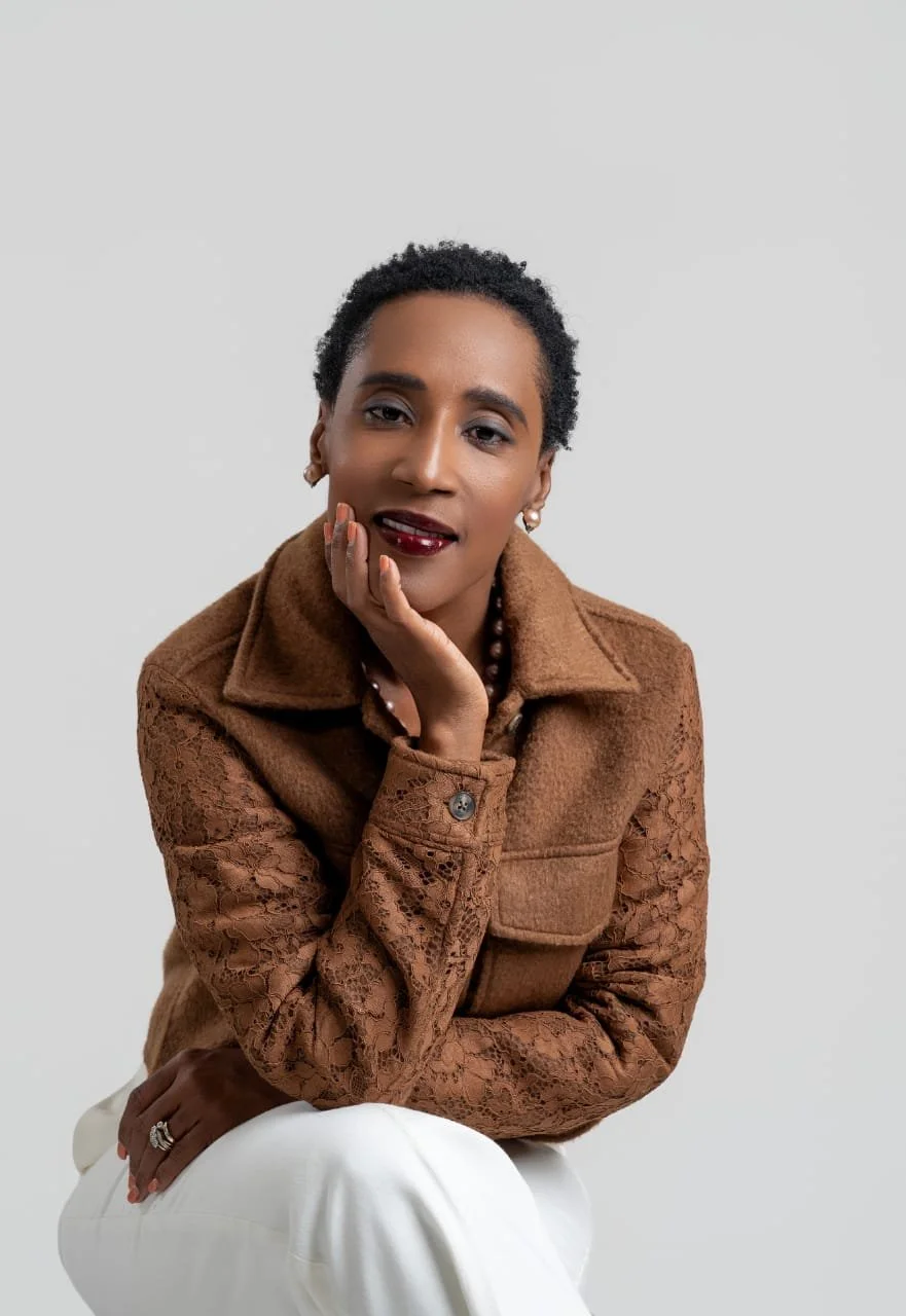 Rolanda Desir Andre seated in a brown jacket